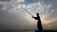 ماهیگیری یک روحانی کنار ساحل